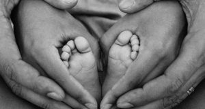 grayscale-photo-of-person-holding-feet-and-hands-1912359